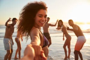 Point Of View Shot Of Friends Enjoying Summer Beach Vacation
